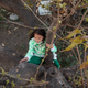 Holland climbs a tree in her family’s backyard.